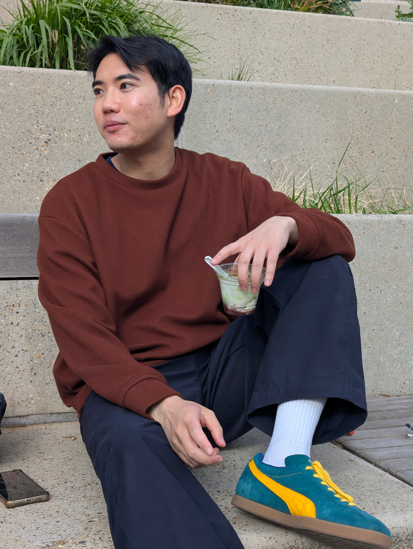Mat sitting on steps with a green drink